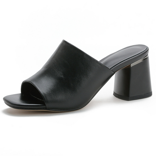 A pair of all-leather fashion square toe mid-high heel slippers featuring a chic and contemporary design. These slippers have a comfortable square toe box and a sturdy mid-high heel for added elegance. The soft leather material provides durability and style, making them perfect for both casual and dressy occasions