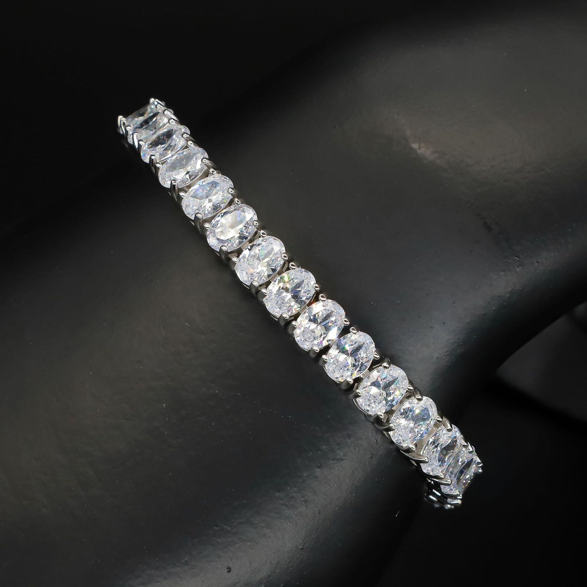 A 925 sterling silver tennis bracelet featuring egg-shaped zircon stones. This elegant bracelet showcases a series of sparkling zircon gems set in polished silver, with a delicate yet secure clasp. Perfect for adding a touch of sophistication and glamour to both casual and formal outfits, offering a timeless and luxurious accessory