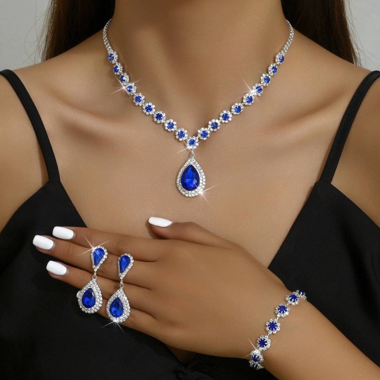 Elegant bridal jewelry set with rhinestone necklace, earrings, and bracelet. Available in White, Sapphire Blue, Red, and Holes Green. Perfect for weddings