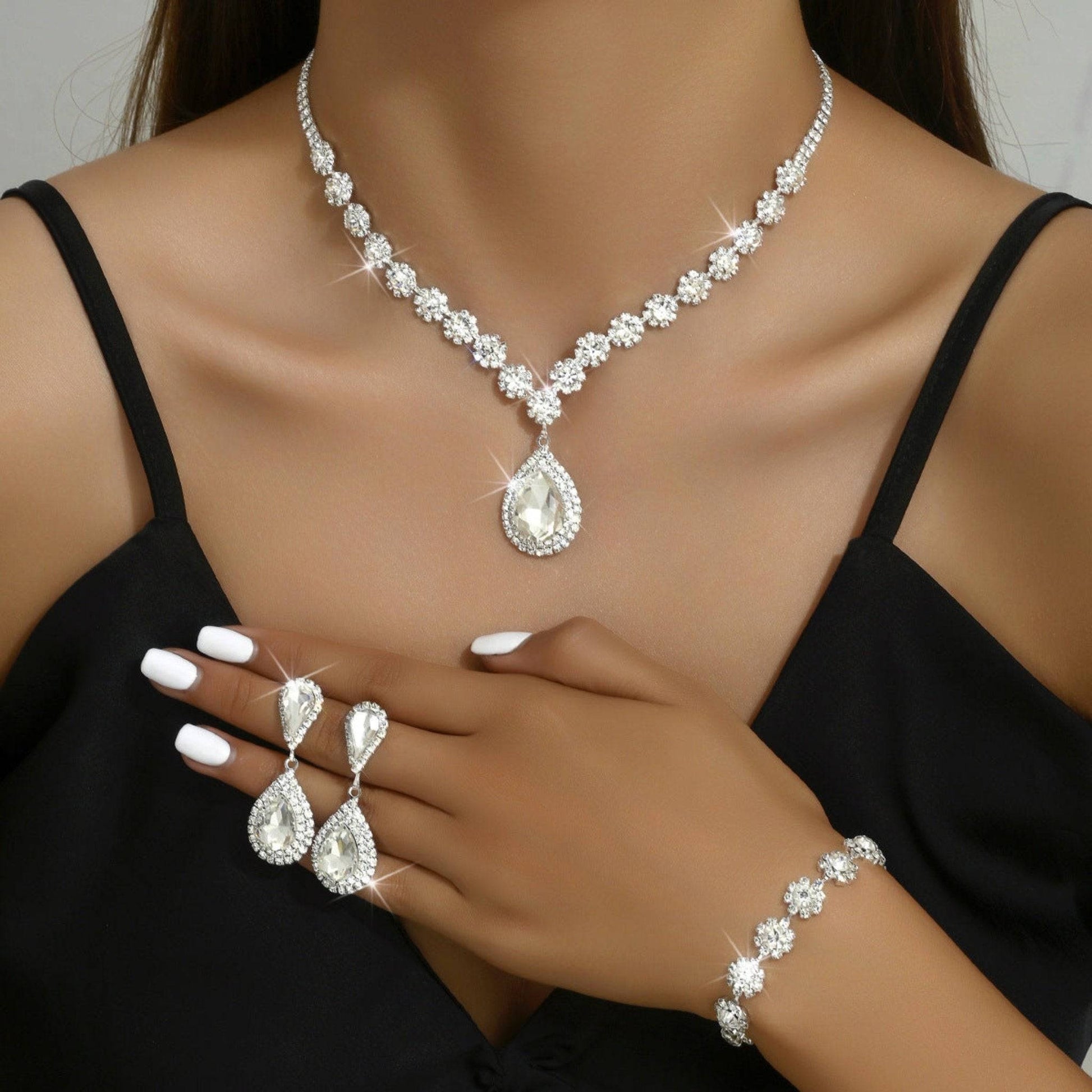 Elegant bridal jewelry set with rhinestone necklace, earrings, and bracelet. Available in White, Sapphire Blue, Red, and Holes Green. Perfect for weddings