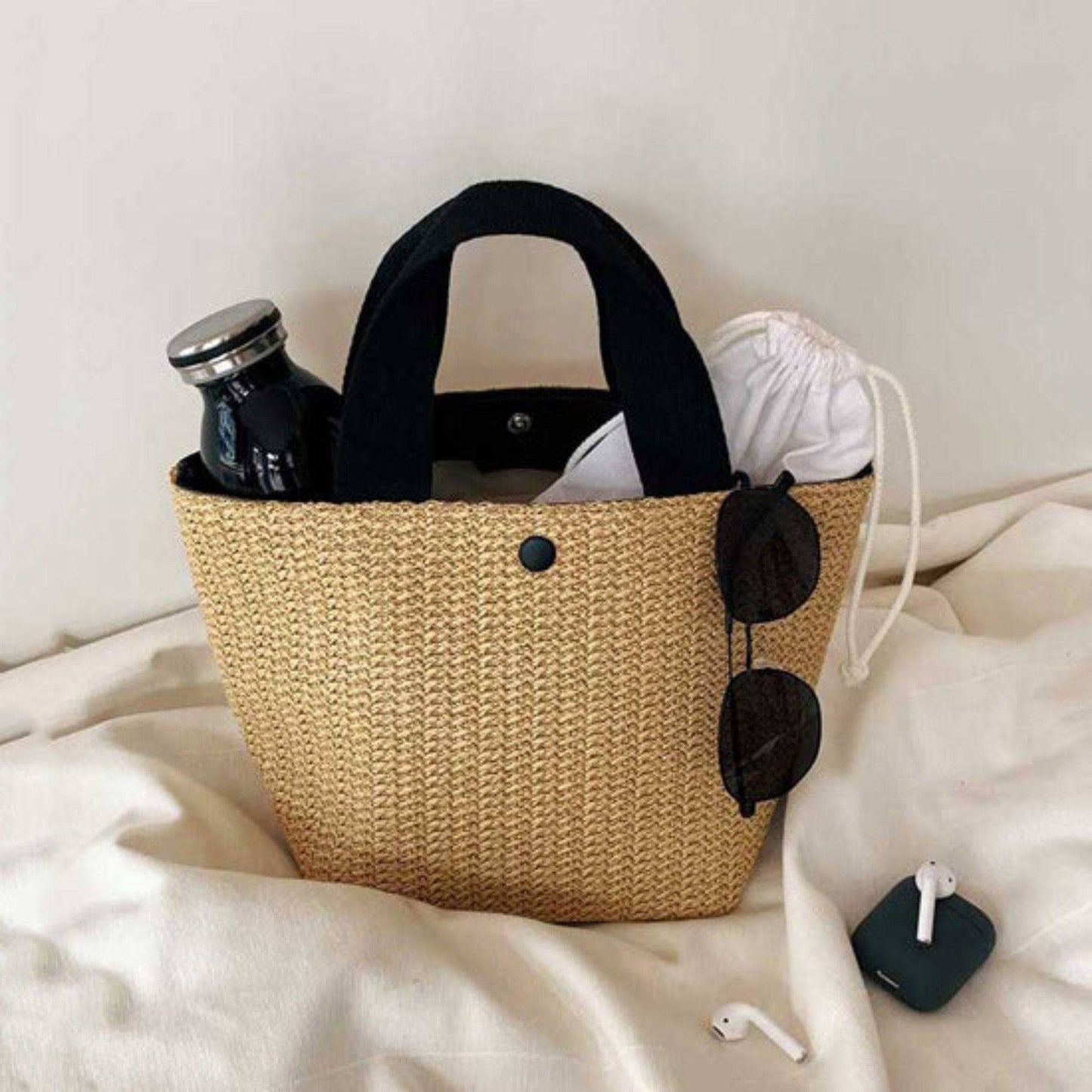 Straw shoulder bag with bucket shape, casual and trendy design, made from rattan, available in black and white, perfect for women’s daily use