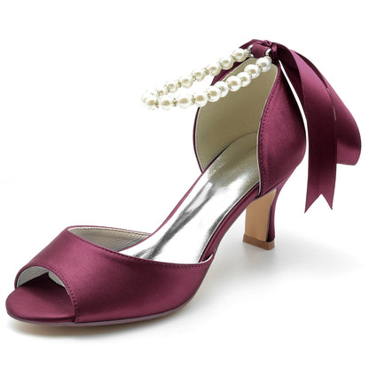 Chunky heel pearl chain ribbon high heels for women. Fish mouth toe, satin upper with rhinestones, lace, and flower details. Mid heel stiletto for elegance