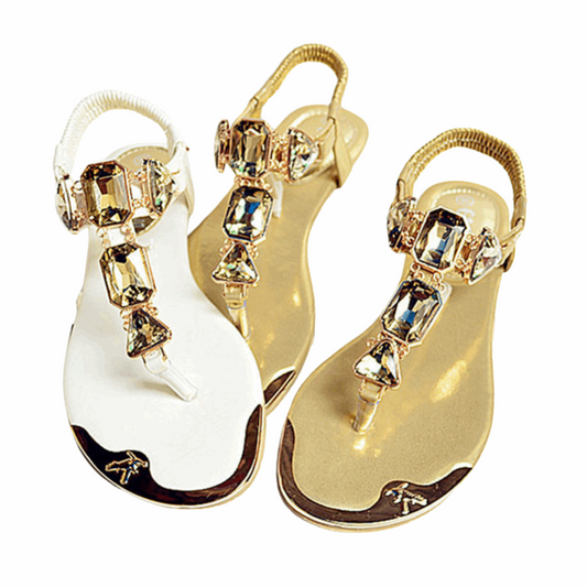 Elegant flat sandals adorned with sparkling crystals, featuring a simple yet glamorous design. Perfect for adding a touch of shine to casual or formal outfits.