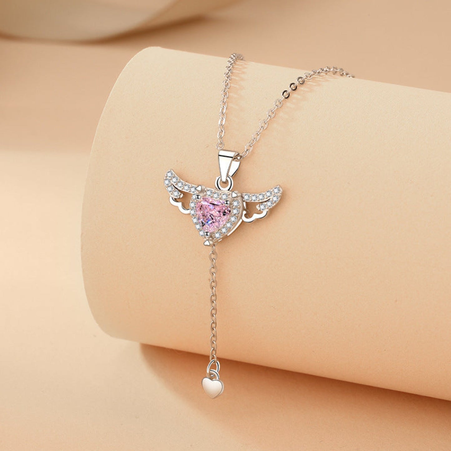  Delicate Cupid-inspired necklace featuring a heart charm with wings and elegant tassels, creating a romantic and whimsical look. Perfect for adding a touch of charm and personality to any outfit.