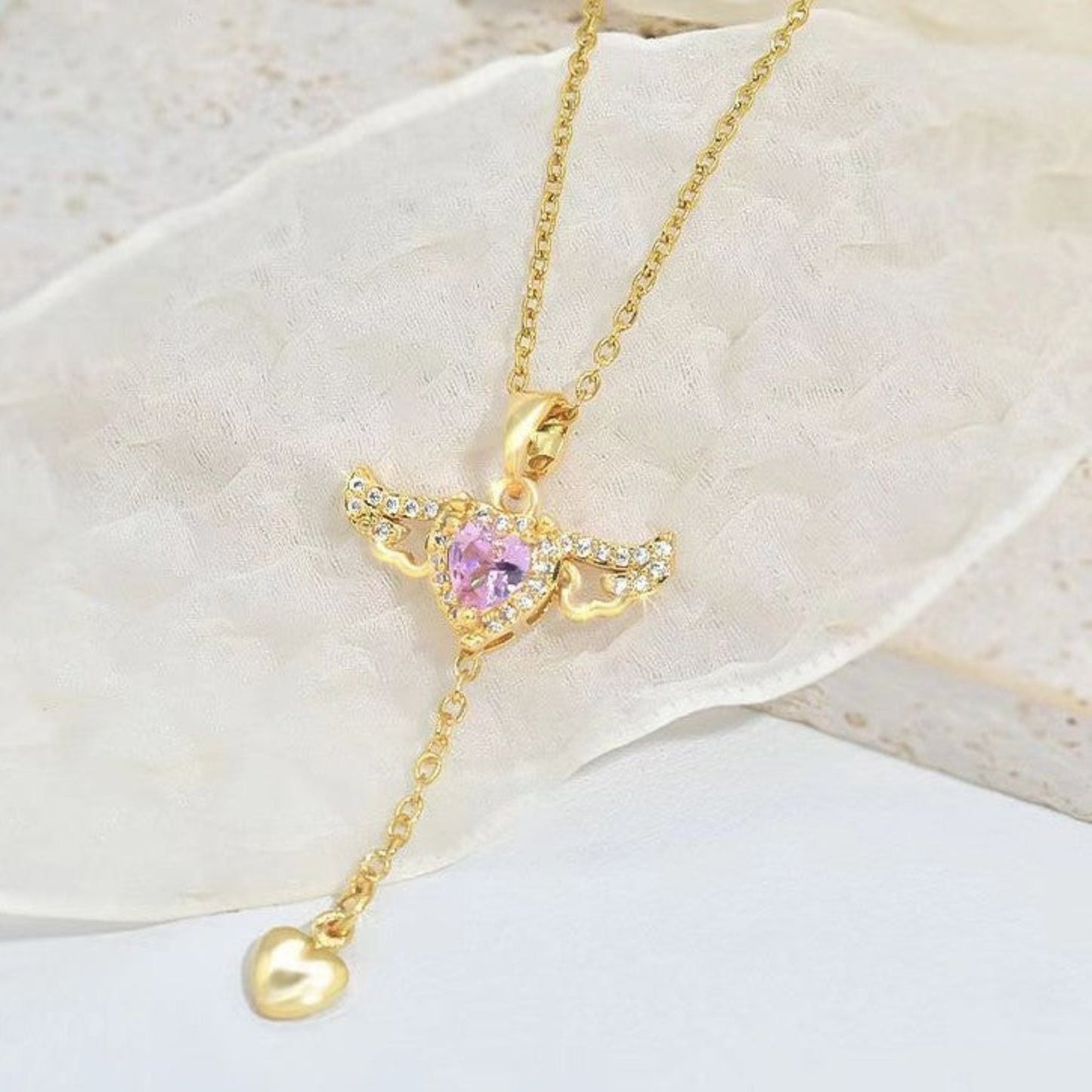  Delicate Cupid-inspired necklace featuring a heart charm with wings and elegant tassels, creating a romantic and whimsical look. Perfect for adding a touch of charm and personality to any outfit.