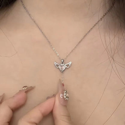  Delicate Cupid-inspired necklace featuring a heart charm with wings and elegant tassels, creating a romantic and whimsical look. Perfect for adding a touch of charm and personality to any outfit.