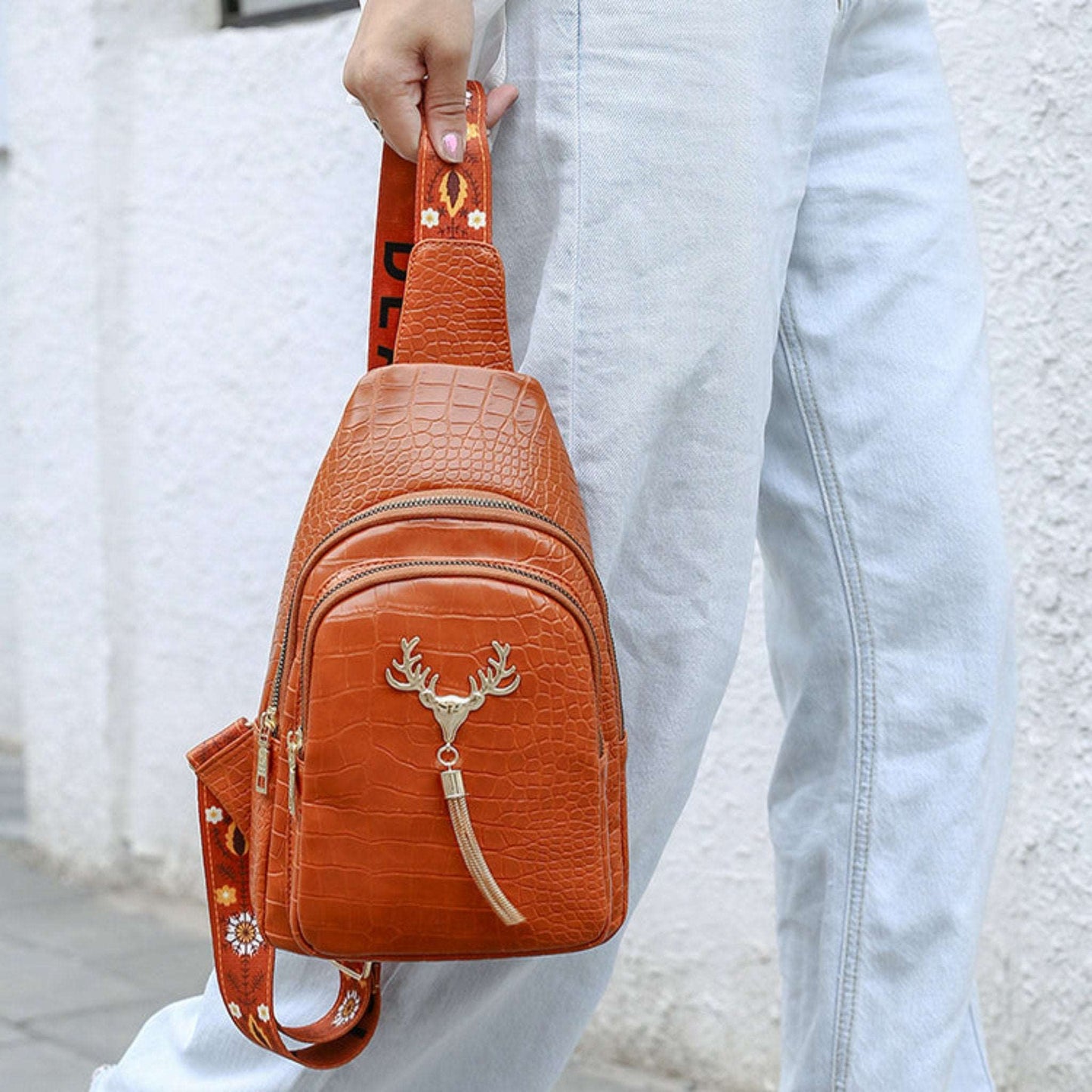 Chic crossbody bag adorned with a deer motif and stylish tassels. This trendy accessory combines functionality with a unique design, making it perfect for everyday use or a night out.