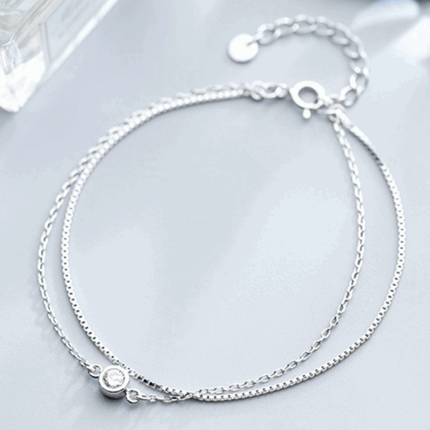 Stunning double-layer silver bracelet adorned with shimmering diamonds. This elegant piece offers a modern yet timeless design, perfect for adding a touch of glamour to any outfit.