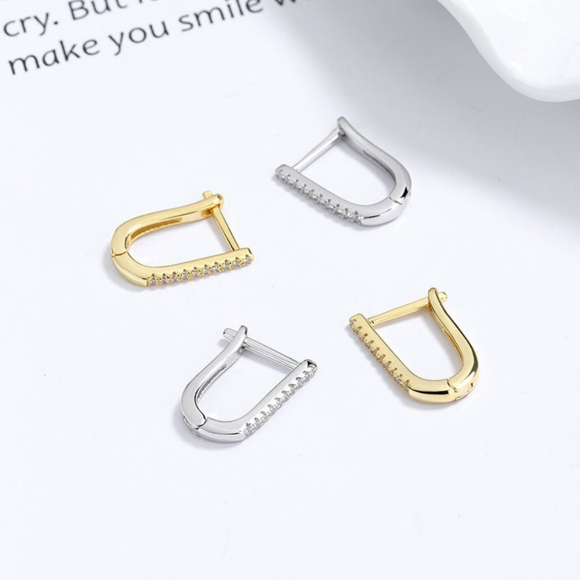 A pair of 925 silver geometric U-shaped earrings with a minimalist and modern design. These earrings feature a sleek U-shaped curve with a polished silver finish, offering a subtle yet elegant look. Ideal for both casual and formal outfits, these lightweight earrings provide a stylish and versatile accessory option