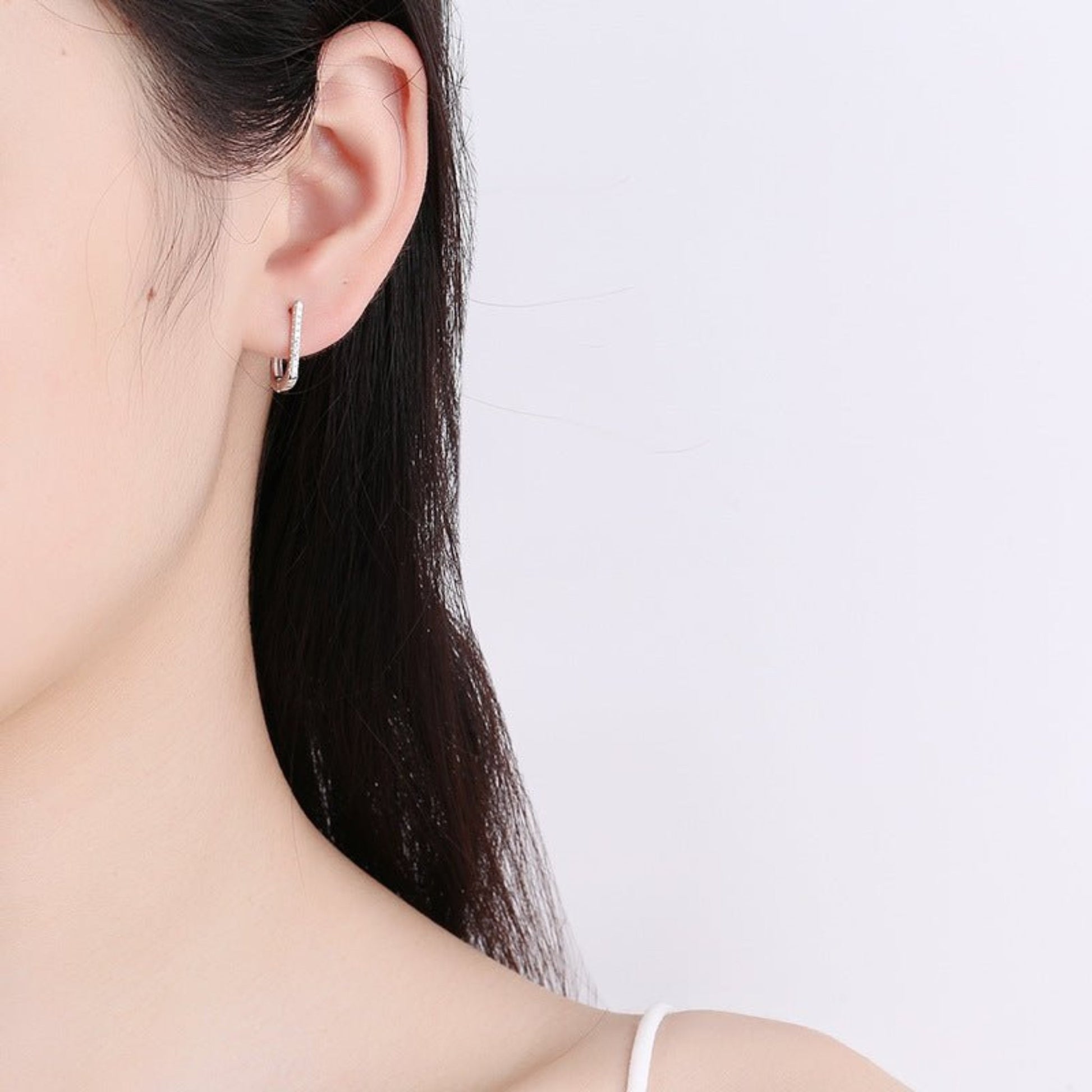 A pair of 925 silver geometric U-shaped earrings with a minimalist and modern design. These earrings feature a sleek U-shaped curve with a polished silver finish, offering a subtle yet elegant look. Ideal for both casual and formal outfits, these lightweight earrings provide a stylish and versatile accessory option